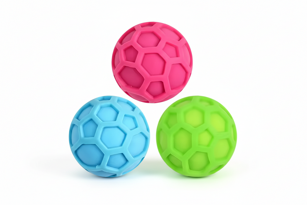 Three colorful textured  quiet stress balls (pink, blue, green) on a white background