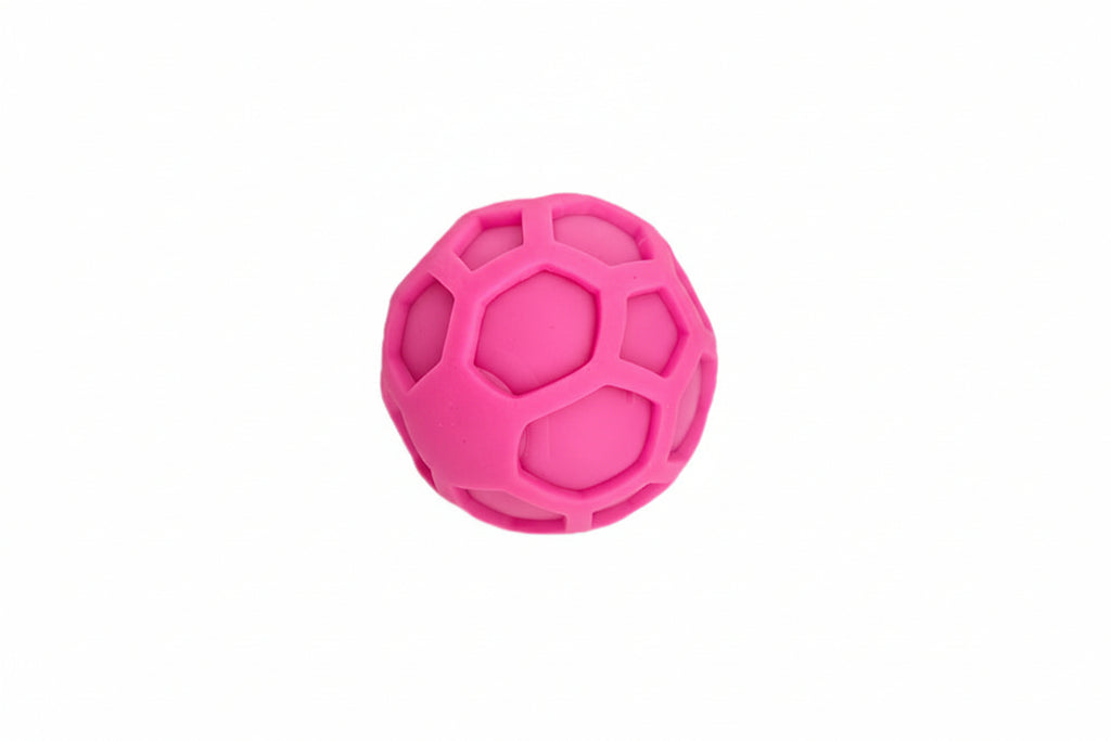 Quiet Pink textured squeeze ball for focus on a white background