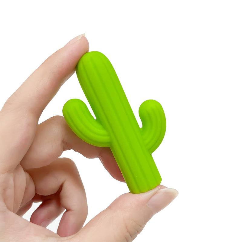 Child using cactus pen topper while writing