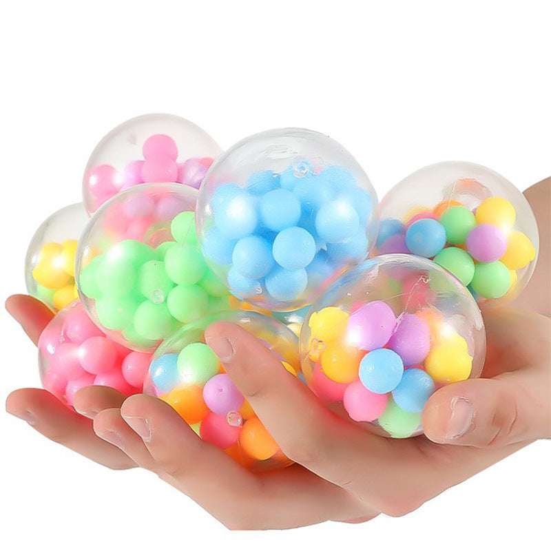 Clear balls filled with colorful beads held by child for sensory sensation