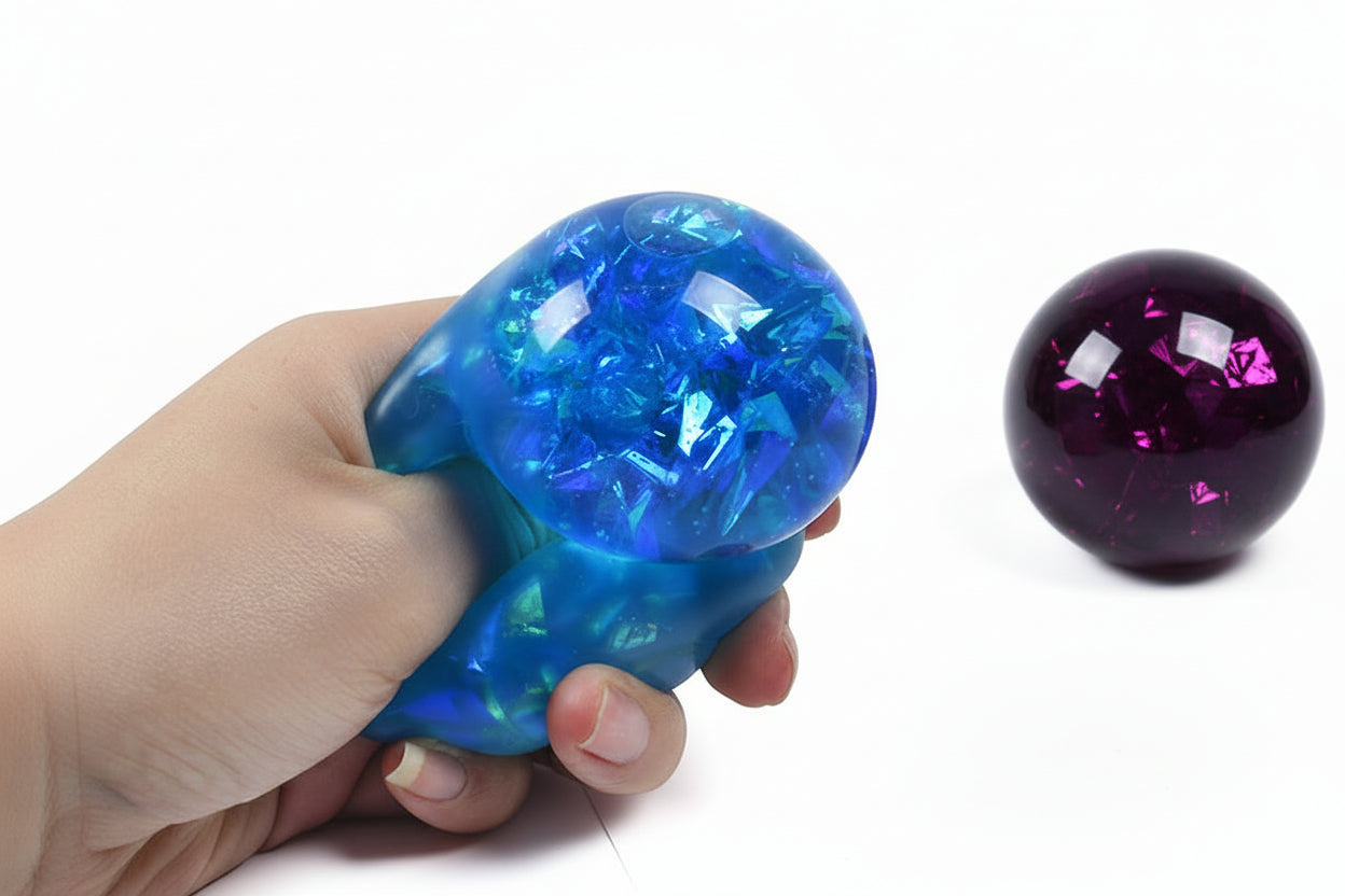 Child squeezing ribbon sensory ball for calming effect