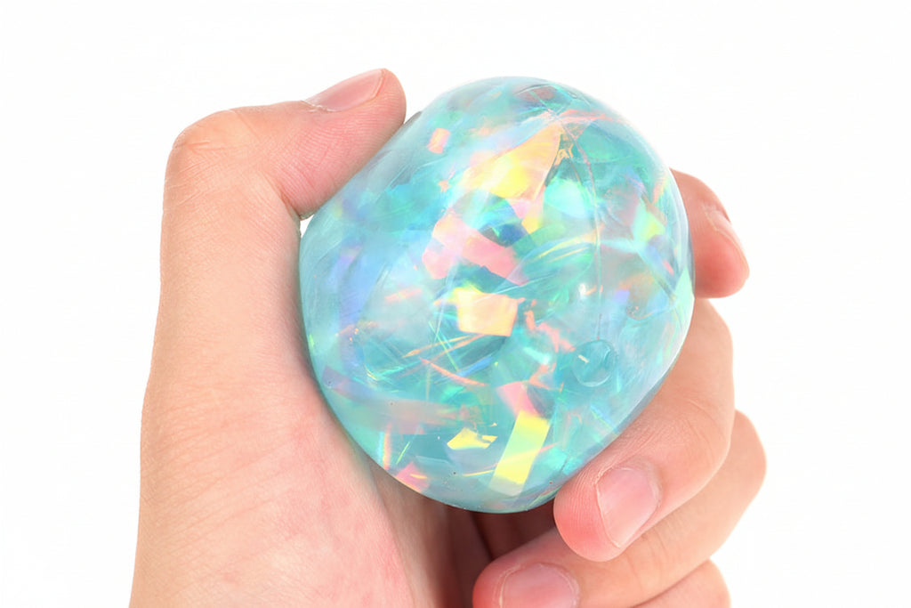 Child squeezing ribbon sensory ball for calming effect