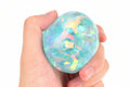 Child squeezing ribbon sensory ball for calming effect